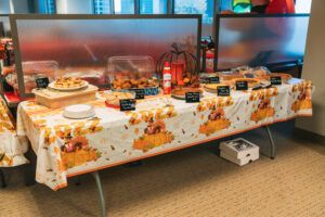 A selection of homemade pies, including pumpkin, pecan, and apple, on display at the 2022 Westmount Realty office Thanksgiving potluck.